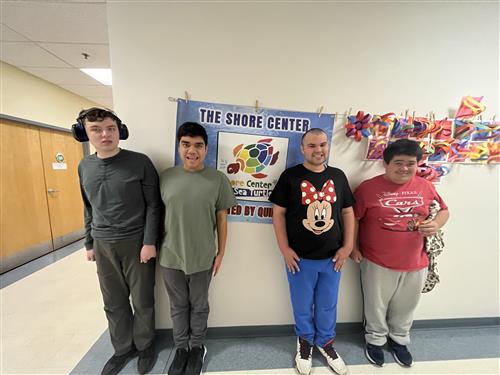 picture of the student council members against a wall with the shorecenter banner and other art work